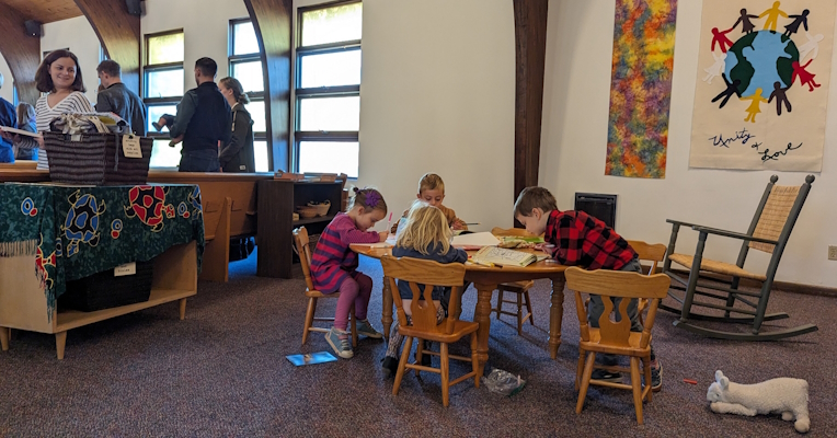 Children at table in rear of sanctuary